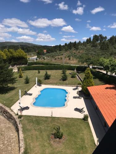 an overhead view of a swimming pool in a yard at Restaurante Residencial Pizzaria S. Estevão in Aguiar da Beira