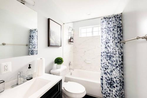 アナポリスにあるBeautiful 6BR home in Annapolisのバスルーム(白いバスタブ、トイレ、シンク付)