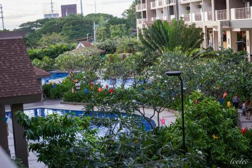 a view of a resort with a pool and plants at Alea Residences in Manila