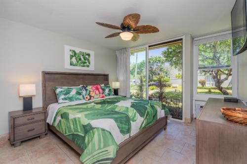 a bedroom with a bed and a ceiling fan at Kuilima Estates East 41 - Plumeria Tree House in Kahuku