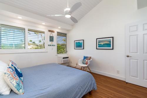 a bedroom with a bed and a window at The Surf Hale - Sleeps 4 - Elevated Surf Aesthetic in Kahuku