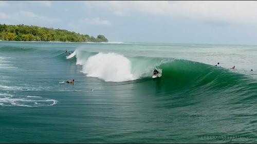 a person riding a wave on a surfboard in the ocean at casa del mar in Bocas del Toro