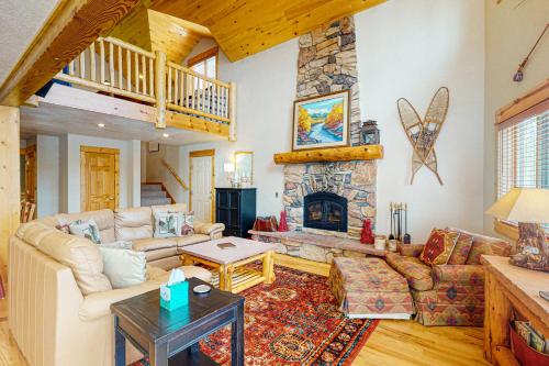 a living room with a couch and a fireplace at Sunset Chalet in Tabernash