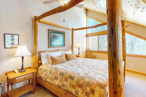 a bedroom with a wooden bed with a wooden frame at Sunset Chalet in Tabernash
