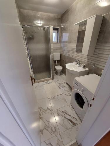 a bathroom with a shower and a toilet and a sink at Apartman AnTe in Korčula