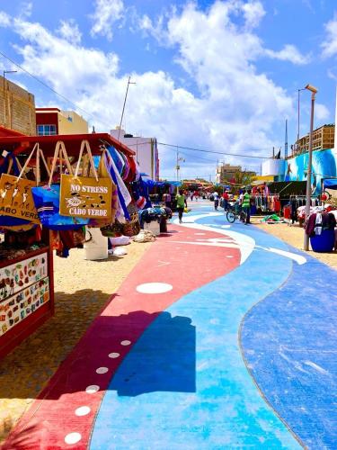 a street with a red white and blue painted sidewalk at Animoss! Apartments - 10 modern apartments near city center & beach in Santa Maria