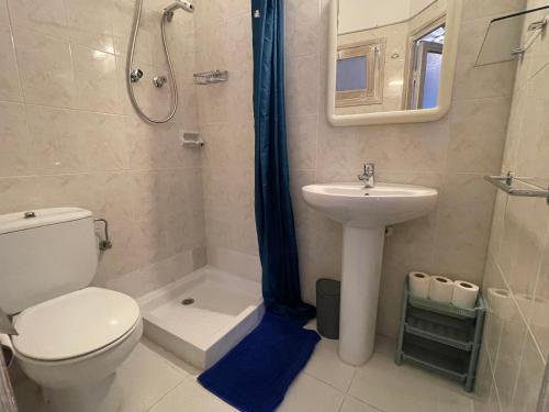 a bathroom with a toilet a sink and a shower at P&R hostals Can Tort in Tossa de Mar