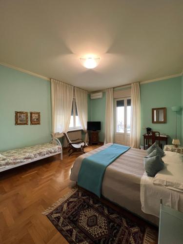 a bedroom with a large bed and a chair in it at B&B Villa Dall'Agnola in Garda