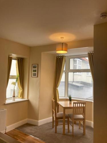 a dining room with a table and chairs and a window at Arkleside Country Guest House in Reeth