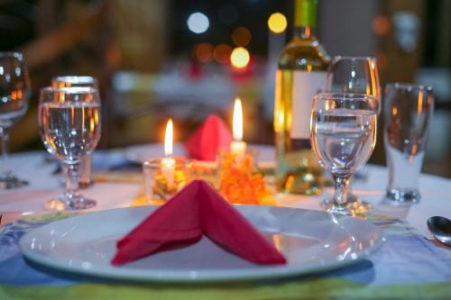 a plate with a napkin on a table with wine glasses at Casa Drake Lodge in Drake