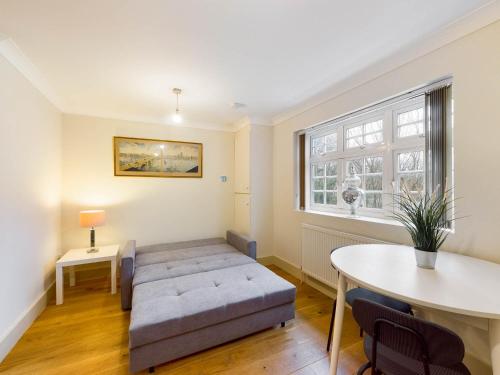 a living room with a couch and a table at Redhill town centre apartments by Livingo in Redhill