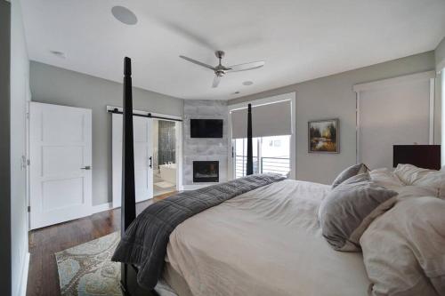 a bedroom with a bed and a ceiling fan at City Views RoofTop Hot Tub & Short Walk to Stadium in Charlotte