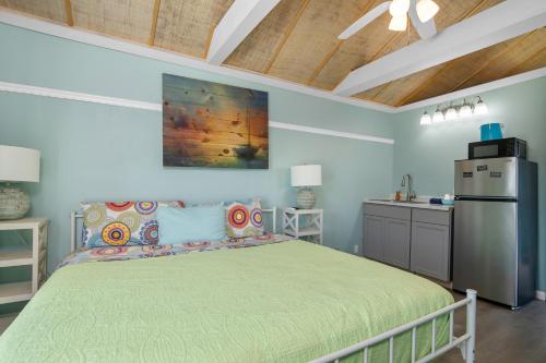 a bedroom with a bed and a kitchen in it at Latitude 26 Waterfront Resort and Marina in Fort Myers Beach