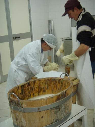 two chefs in a kitchen preparing food in a kitchen at Aia di Lazzaro Agriturismo in Casalbore