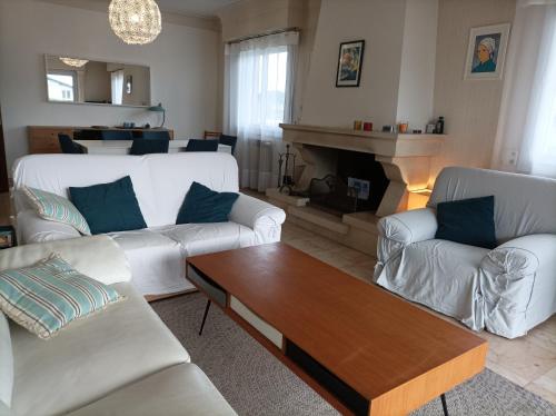 a living room with two white couches and a fireplace at GARAT in Saint-Jean-de-Luz