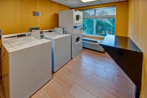 a laundry room with white appliances and a window at Fairfield Inn and Suites by Marriott Orlando Near Universal Orlando in Orlando