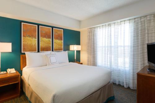 a hotel room with a bed and a window at Residence Inn by Marriott Austin Parmer/Tech Ridge in Austin