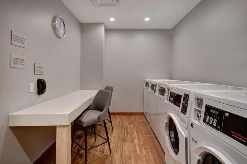 a laundry room with a counter and washing machines at TownePlace Suites by Marriott Cincinnati Airport South in Florence