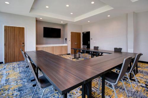 a conference room with a large wooden table and chairs at TownePlace Suites by Marriott Cincinnati Airport South in Florence