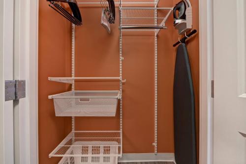 a closet with metal shelves and a umbrella at TownePlace Suites by Marriott El Paso East/I-10 in El Paso