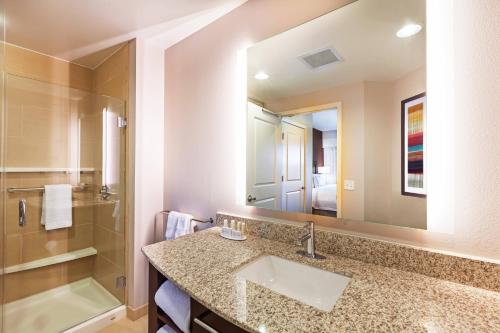 a bathroom with a sink and a shower and a mirror at Residence Inn by Marriott Austin Northwest/The Domain Area in Austin