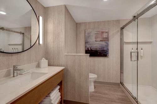 a bathroom with a sink and a toilet and a mirror at Fairfield by Marriott Inn & Suites Minneapolis Downtown in Minneapolis