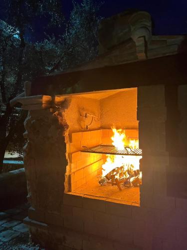a brick oven with a fire in it at La Chianconata in Vieste