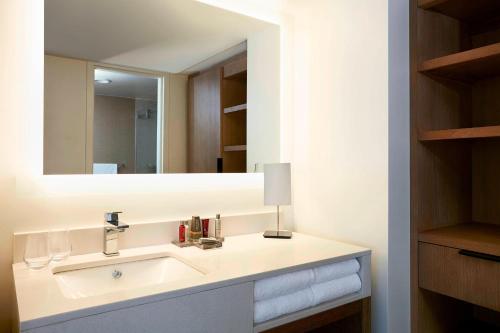 a bathroom with a sink and a mirror at Charlotte Marriott City Center in Charlotte