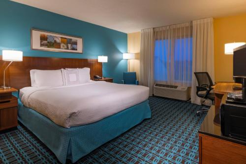 a hotel room with a bed and a television at Fairfield Inn Salt Lake City South in Murray