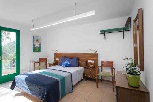 a bedroom with a bed and a desk and chair at Cottage Eco-Friendly Barcelona country side in La Garriga