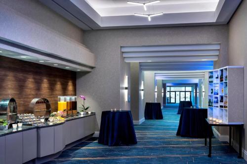 a hotel lobby with two tables and a buffet at BWI Airport Marriott in Linthicum Heights