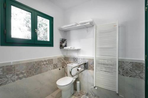 a bathroom with a toilet and a window at Cottage Eco-Friendly Barcelona country side in La Garriga