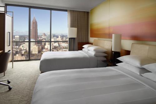 a hotel room with two beds and a large window at Atlanta Marriott Marquis in Atlanta