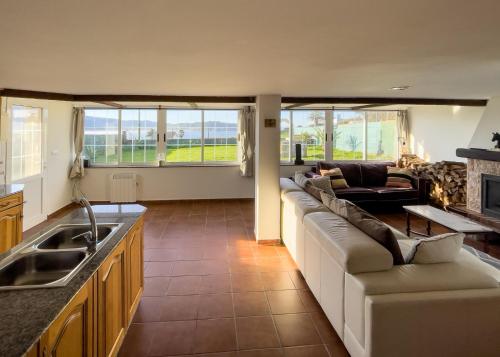 a large living room with a couch and a kitchen at Villa de Melle – Seaview – beach 5 min by foot in Ferrol