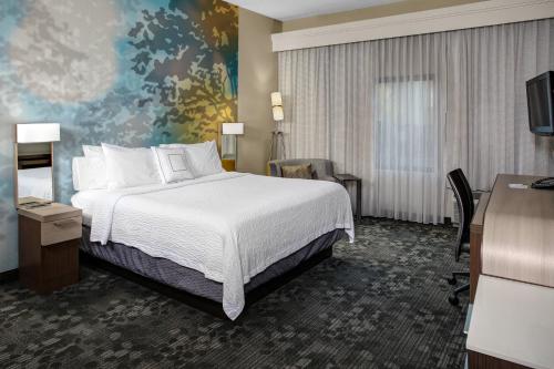 a hotel room with a bed and a desk at Courtyard by Marriott Cleveland Westlake in Westlake