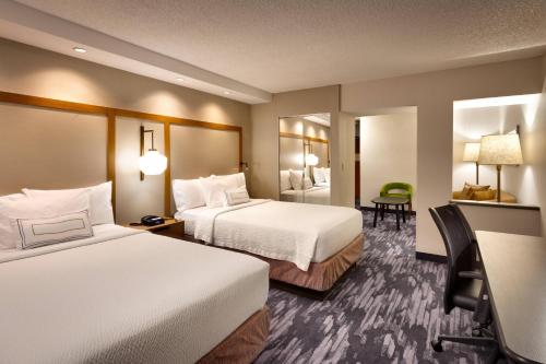 a hotel room with two beds and a desk at Fairfield Inn and Suites Sierra Vista in Sierra Vista