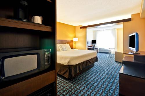 a hotel room with a bed and a television at Fairfield Inn & Suites by Marriott Atlanta Vinings/Galleria in Atlanta