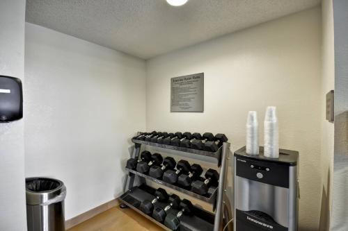 a gym with dumbbells on the wall in a room at Fairfield Inn & Suites by Marriott Atlanta Vinings/Galleria in Atlanta