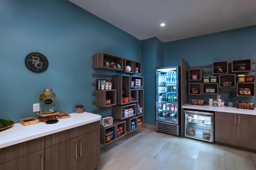 a kitchen with blue walls and a refrigerator at Element Waco in Waco