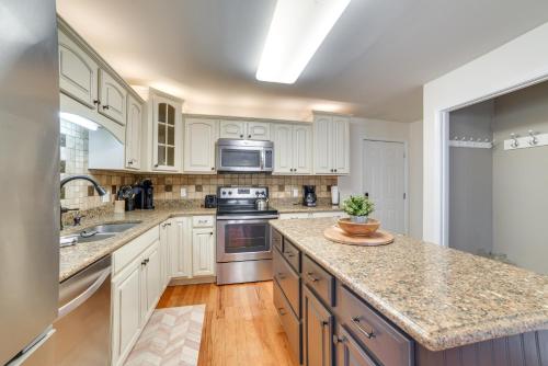 a kitchen with white cabinets and granite counter tops at Cadiz Abode with Decks, Fire Pit, and Lake Access in Cadiz