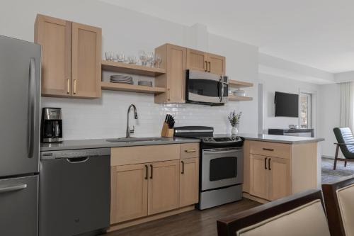 a kitchen with stainless steel appliances and wooden cabinets at Marriott's Fairway Villas in Galloway