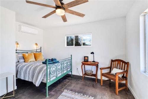 a bedroom with a bed and a ceiling fan at Cozy Fresh Desert Hideaway, 5 mins to Joshua Tree in Twentynine Palms