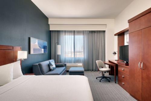 a hotel room with a bed and a desk at Courtyard Lincoln Downtown in Lincoln