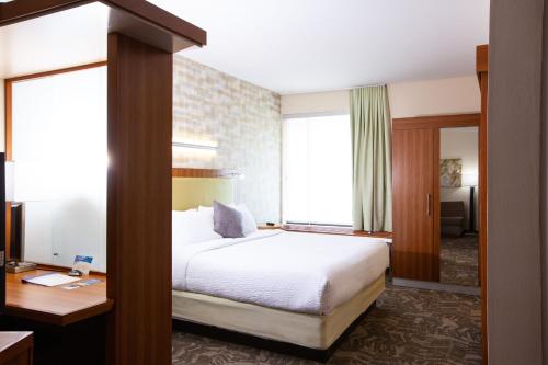 a hotel room with a bed and a desk at SpringHill Suites Wenatchee in Wenatchee