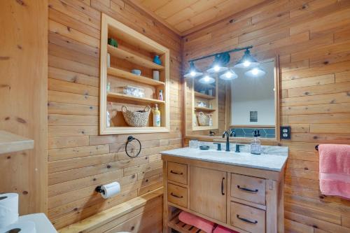 a bathroom with a sink and a mirror at Leavenworth Cabin with Private Hot Tub! in Leavenworth