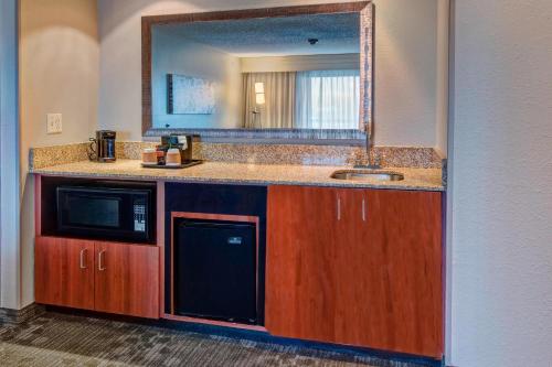 a kitchen with a sink and a microwave at Courtyard by Marriott Alexandria in Alexandria