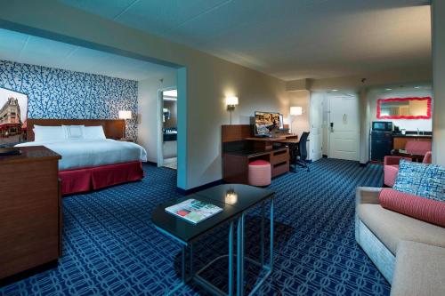 a hotel room with a bed and a couch at Fairfield Inn & Suites by Marriott Lynchburg Liberty University in Lynchburg