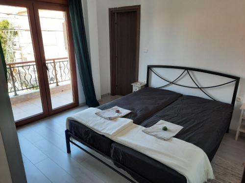 a bedroom with a bed with two towels on it at Olga's appartments in Ouranoupoli