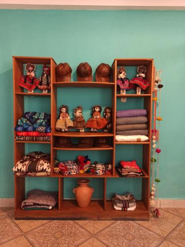 a book shelf filled with lots of knick knacks at Casa D´Maria in Ollantaytambo