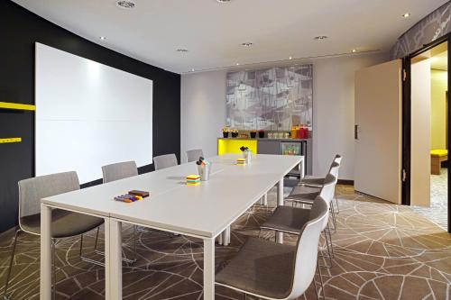 a conference room with a white table and chairs at Cologne Marriott Hotel in Cologne